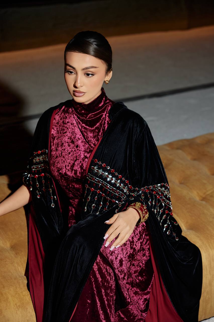 A black velvet bisht set with a burgundy dress.C:379