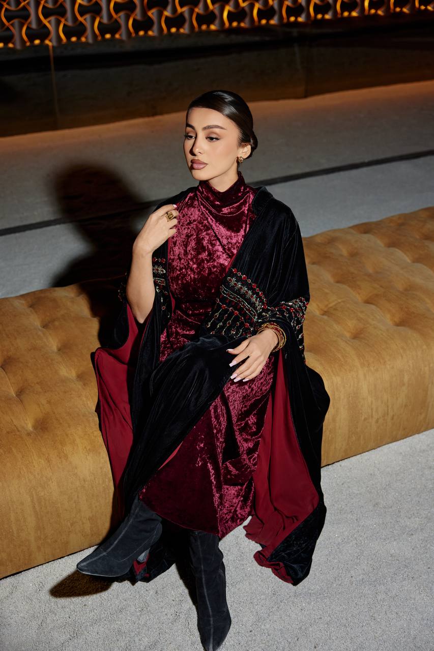 A black velvet bisht set with a burgundy dress.C:379