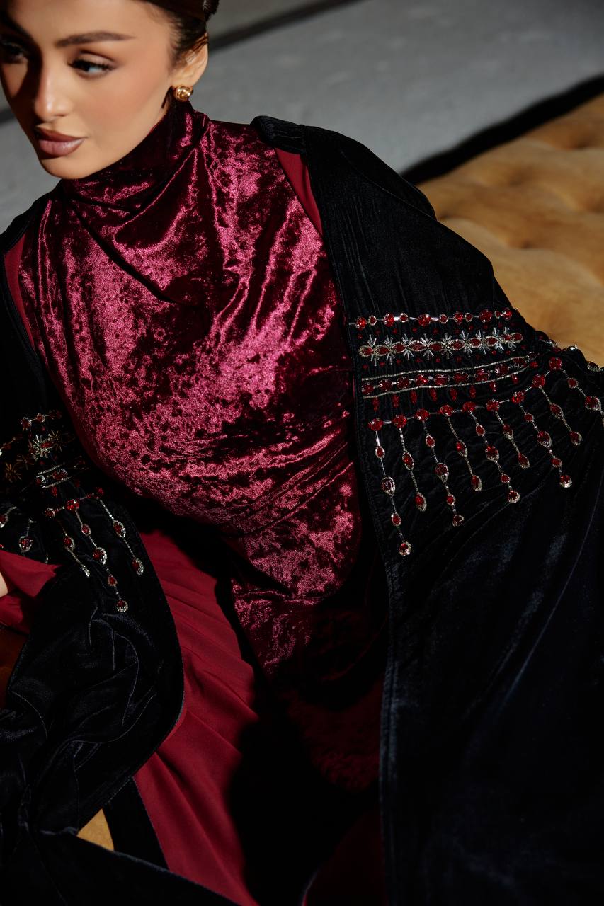 A black velvet bisht set with a burgundy dress.C:379