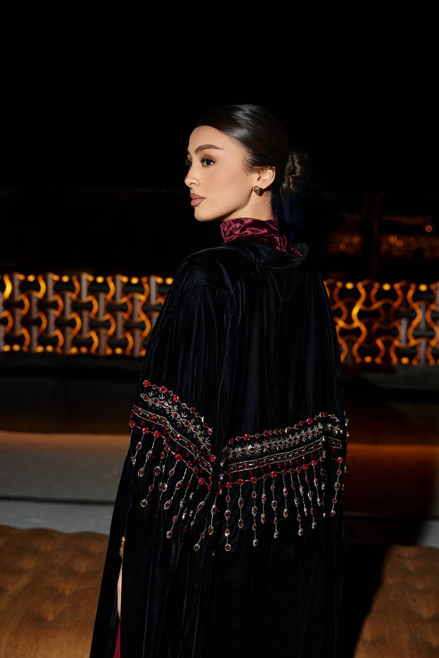 A black velvet bisht set with a burgundy dress.C:379